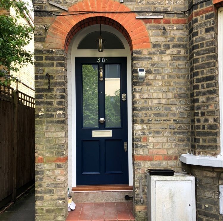 Navy blue front door with brass fittings